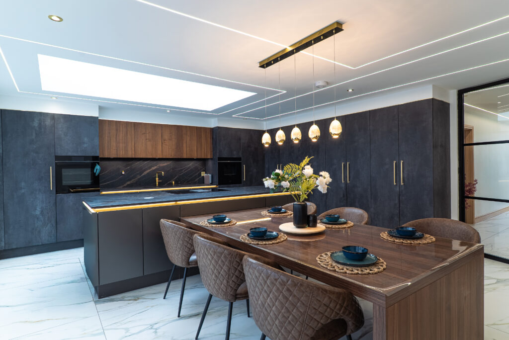 Contemporary kitchen with a central island, dining table and rooflight