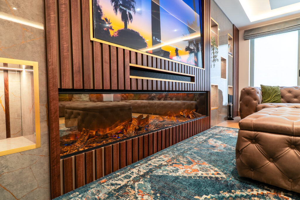 Living room media wall with timber panelling and a linear fireplace