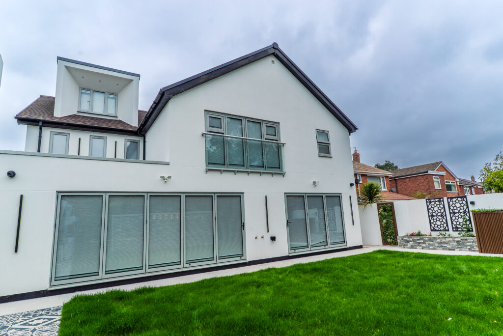 Rear elevation of a three-storey house with glazing overlooking the garden